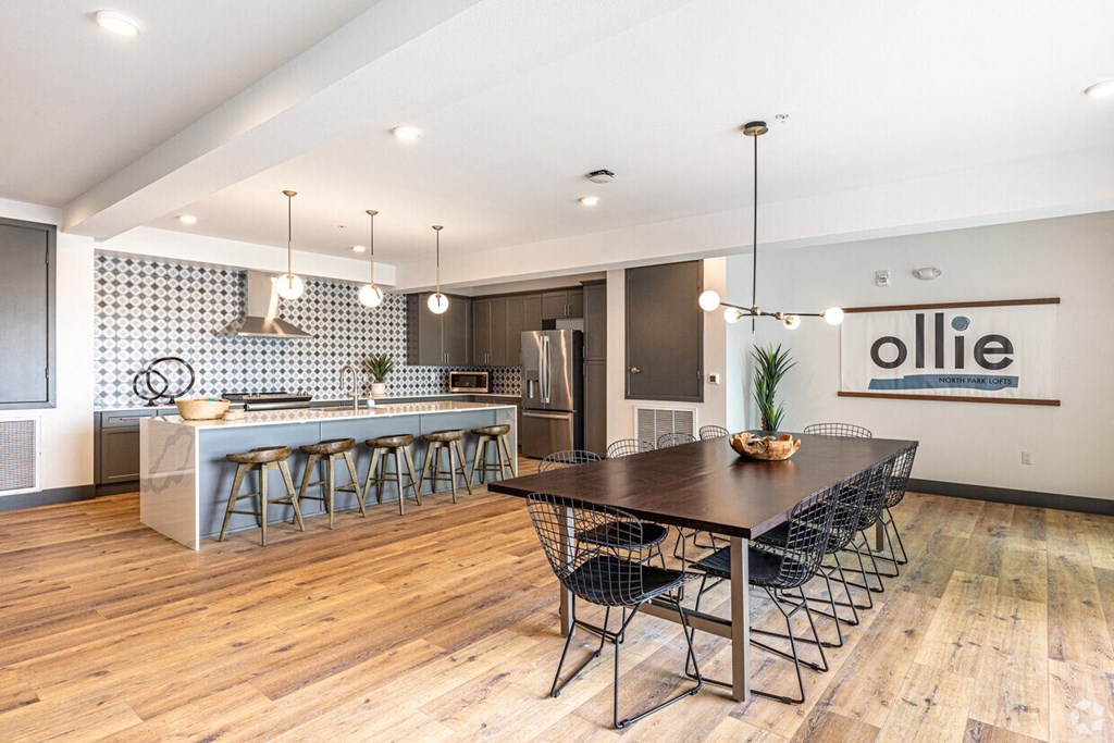 a dining room and kitchen with a table and chairs