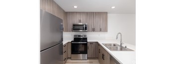 a kitchen with wooden cabinets and stainless steel appliances