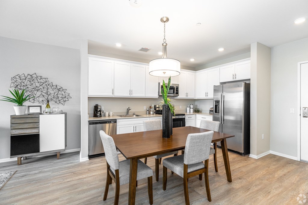 a kitchen and dining room with a table and chairs