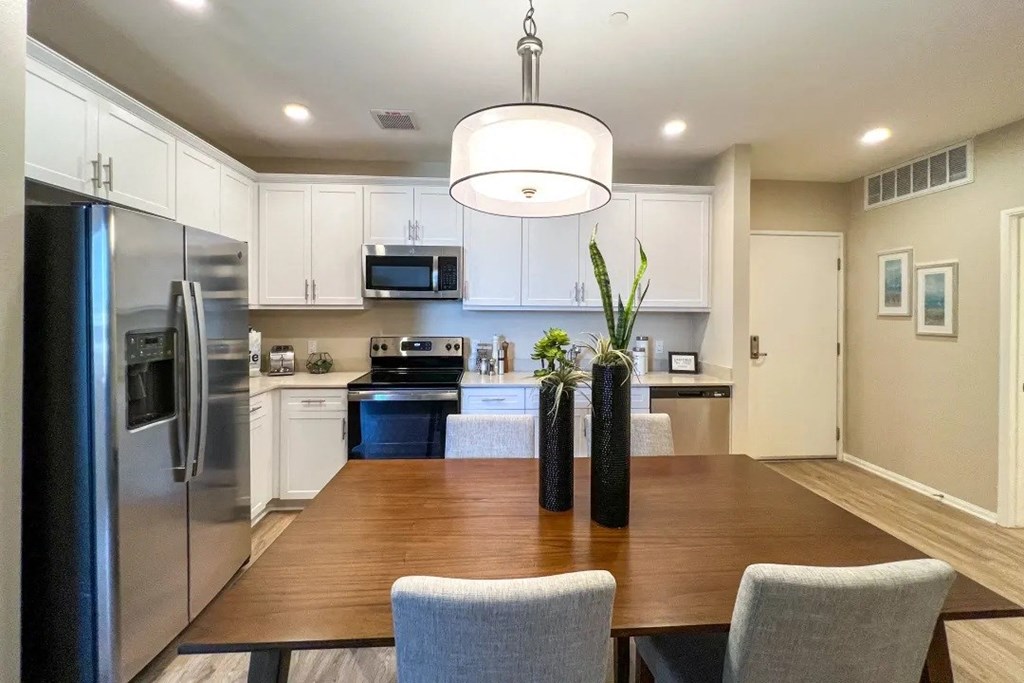 a kitchen and dining room with a wooden table