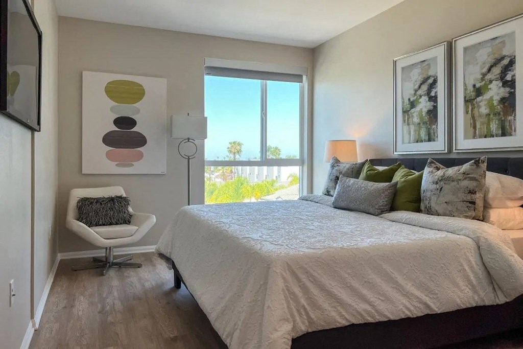 a bedroom with a large bed and a window