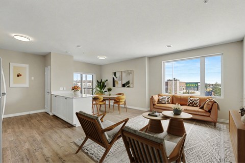 A living room with a couch, chairs, and a coffee table.