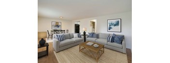A living room with a grey couch and a coffee table.