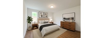 A bedroom with a large bed, a nightstand, and a dresser.