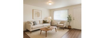 A living room with a couch, chair, and table.