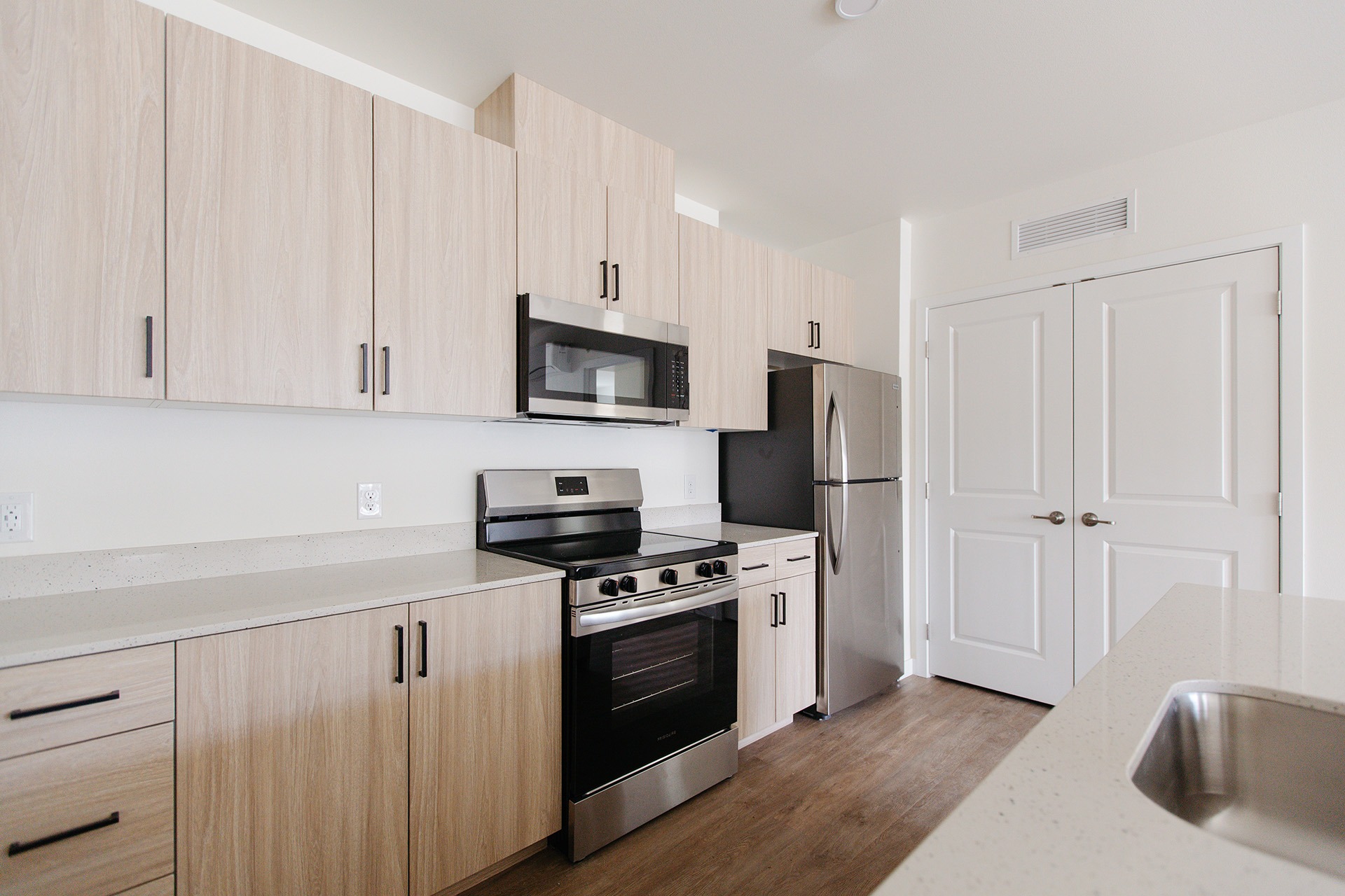 A kitchen with wooden cabinets and stainless steel appliances.