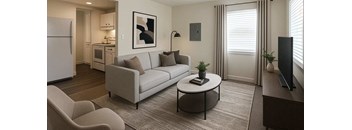 A modern living room with a white sofa, a grey armchair, and a coffee table.