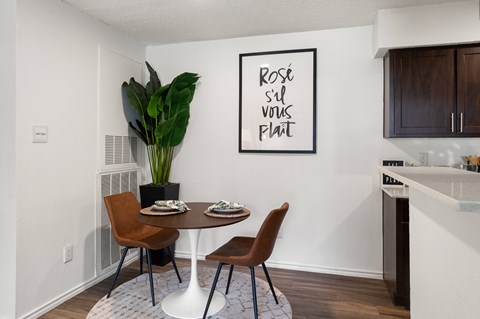 Dining nook with round table and brown chairs at Twenty 15 Apartments, Austin, Texas