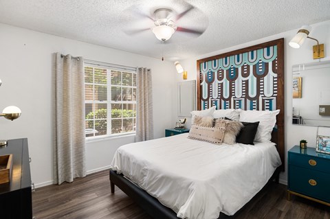 Bedroom with patterned headboard and white bedding at Twenty 15 Apartments, Texas, 78758