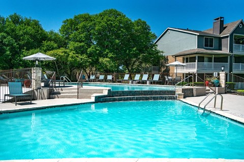 Resort style swimming pool with cascading water features at Twenty 15 Apartments, Austin