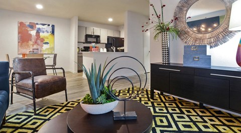 A living room with a brown chair and a plant on a coffee table.