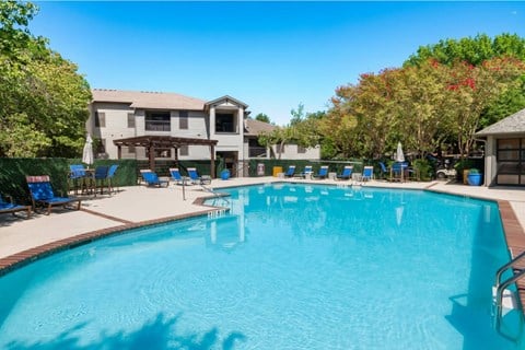 Resort style swimming pool with lounge chairs at Radius at the Domain Apartments, Austin, 78758
