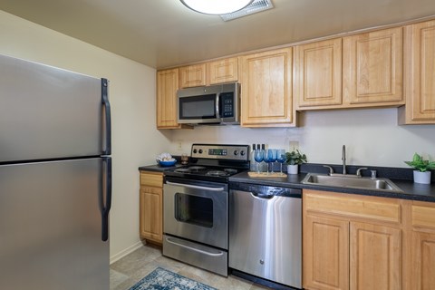 A kitchen with wooden cabinets and stainless steel appliances.