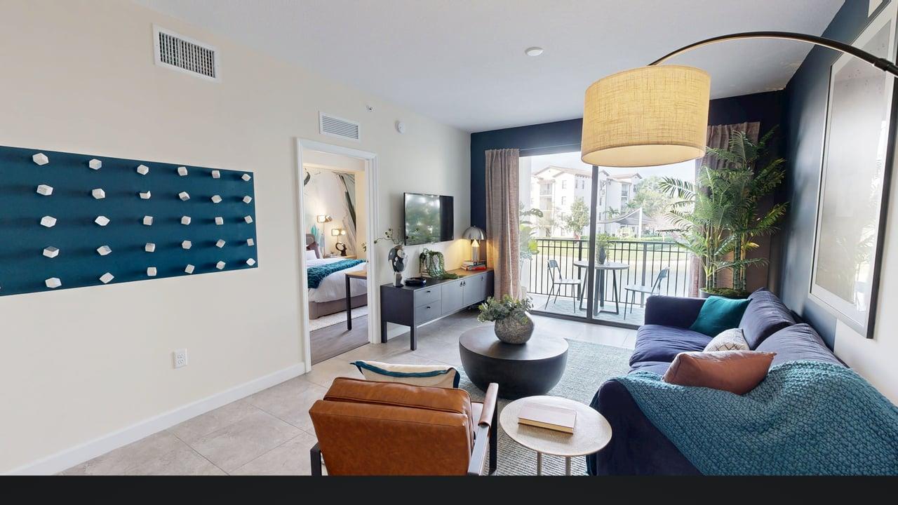 A living room with a blue couch and a television.