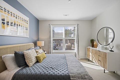 A bedroom with a large bed and a view of the city.