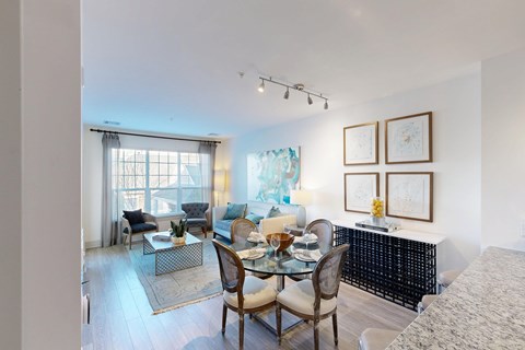 A dining room with a glass table and chairs.