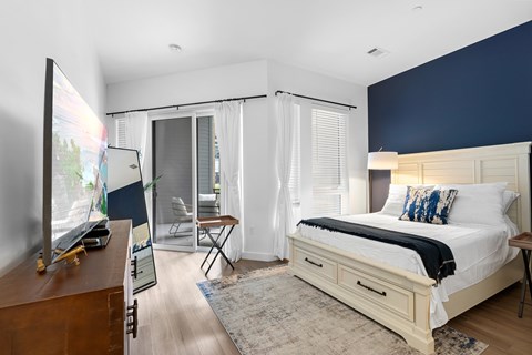 A bedroom with a large bed and a television.