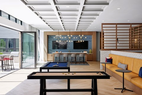 A billiard table is in the middle of a room with a pool table and a bar.