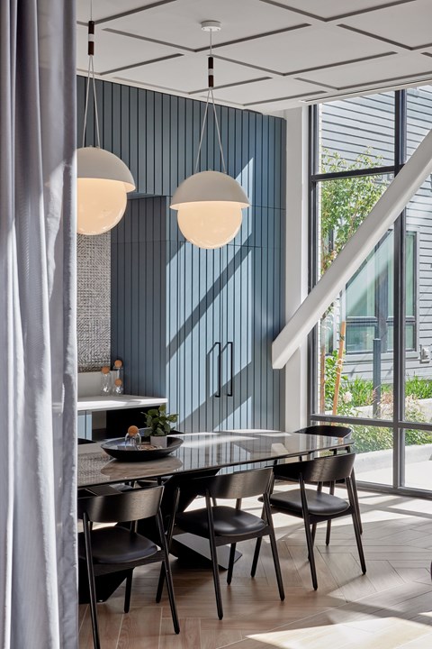 A modern dining room with a table set for two.