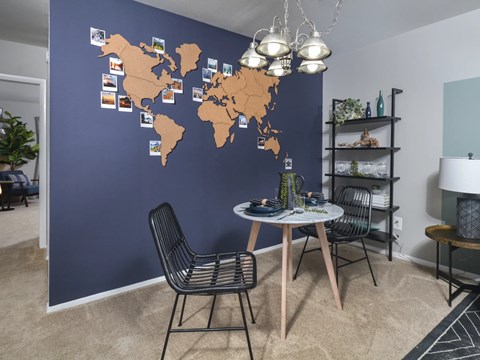 A dining room with a world map on the wall.