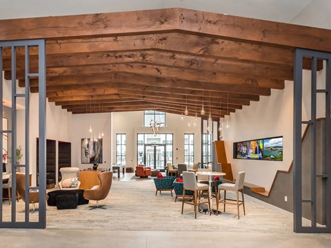 A modern interior with a wooden ceiling and a staircase.
