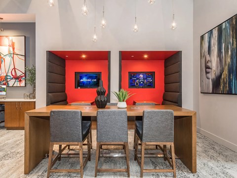 A conference room with a long table and chairs.