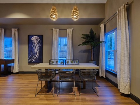 A dining room with a table and chairs.