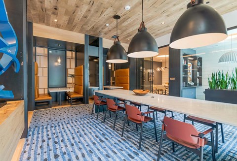 A modern dining area with a long table and chairs.