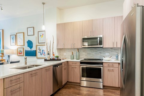 A kitchen with wooden cabinets and stainless steel appliances.
