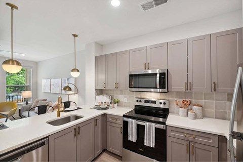 A kitchen with a black stove top oven and a microwave above it.