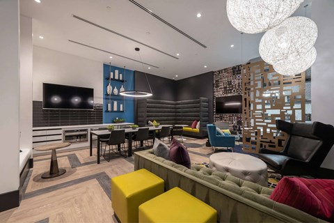 A modern living room with a variety of seating options and a flat screen TV.