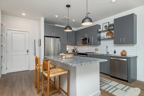 A kitchen with a white door and a wooden chair.