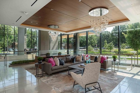 A modern living room with a large couch and a chandelier.