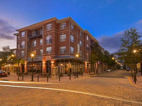 A large red brick building with a balcony on the second floor.