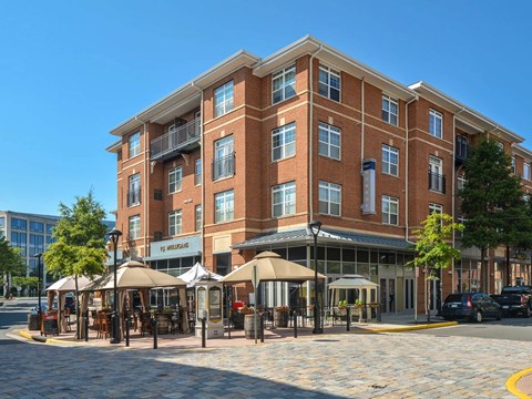 A large brick building with a cafe in front.