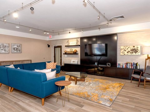 A living room with a blue couch and a television.