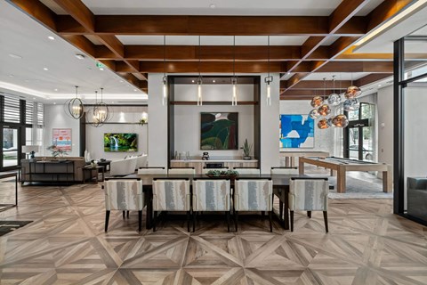A modern dining room with a large table and chairs.
