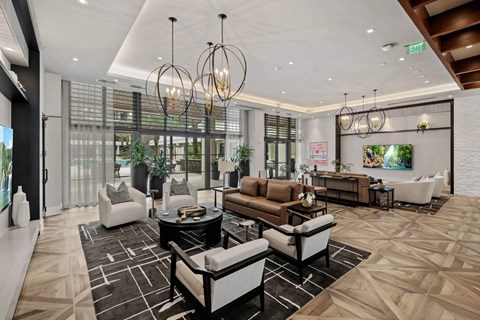 A modern living room with a black and white patterned rug and a variety of seating options.