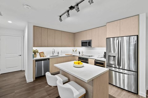 A modern kitchen with a white table and chairs.
