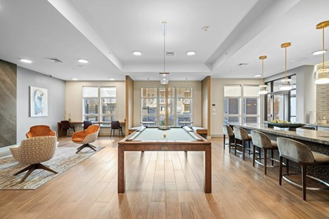 A large room with a pool table and chairs.