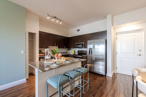 A kitchen with a counter and a refrigerator.