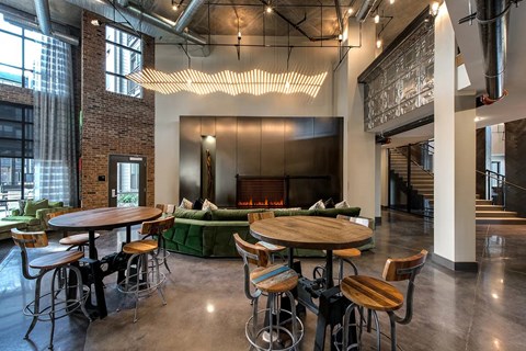 A large room with a fireplace and a long table with chairs.