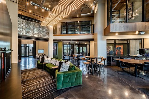A modern open space with a green sofa and a bicycle.