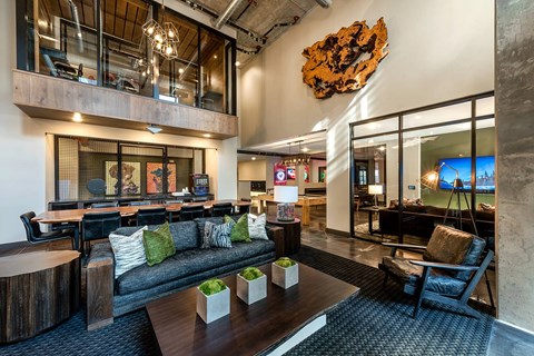 A modern living room with a large couch and a wooden coffee table.