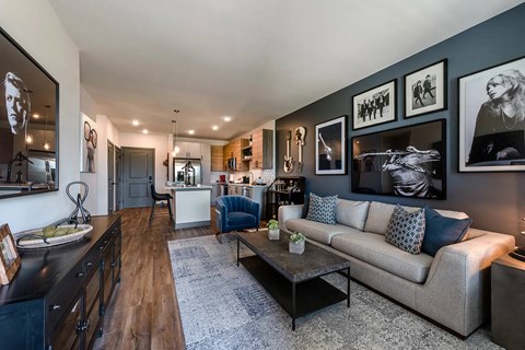 A modern living room with a grey couch and a coffee table.