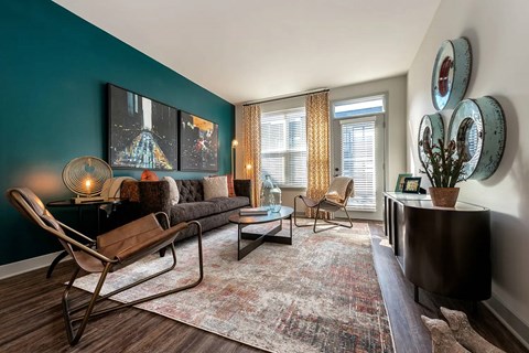 A living room with a blue wall and a chair.