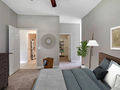 A bedroom with a bed, dresser, and mirror.