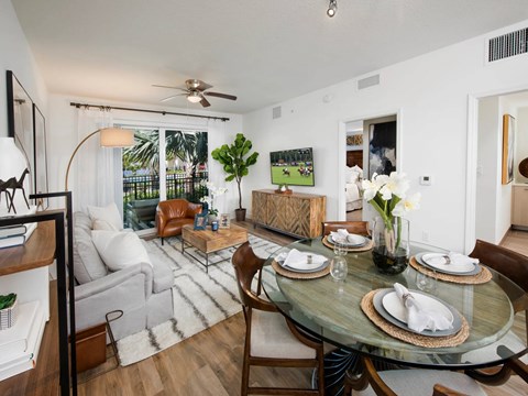 A dining room with a glass table and chairs.