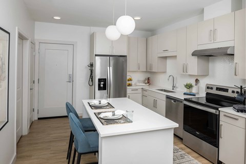 A modern kitchen with a dining table and chairs.