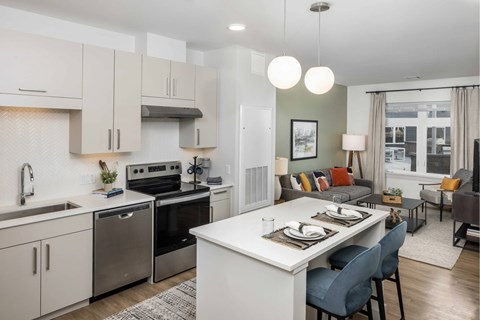 A modern kitchen with a dining area.